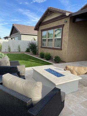 Travertine patio and extension, gas fireplace, turf refresh and border. Also did beautiful raised seating/planter along back and pergola.