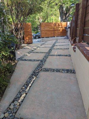 New stamped concrete slabs with Mexican river rock.