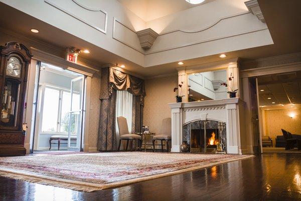 Spacious foyer with two story vaulted ceilings, fireplace and cherry stained oak floors creates a tastefully appointed ambiance.