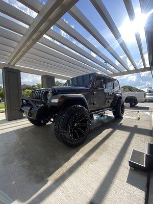 Jeep receiving its bi-weekly wash and spray wax