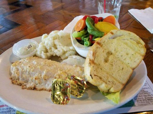 Baked haddock with mash potatoes and veggies.