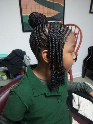 Designer braided bun with side braids with curls.