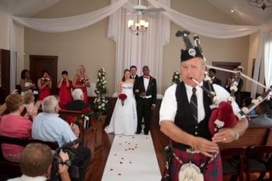 Wedding in progress with bagpipes and wedding guests