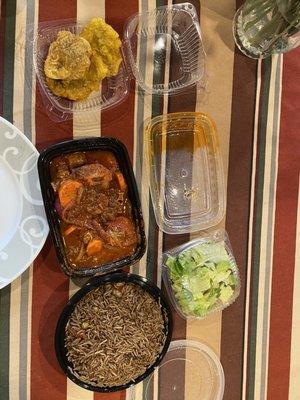 Oxtail, black rice, fried plantains, and side salad. Delicious and filling meal!