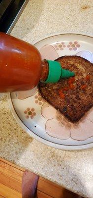 Sprouted Ezekiel bread toasted with sriracha