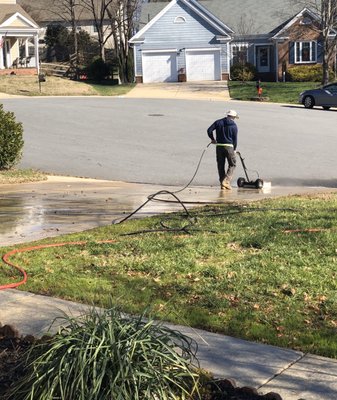 Cleaning my driveway with a buffer.