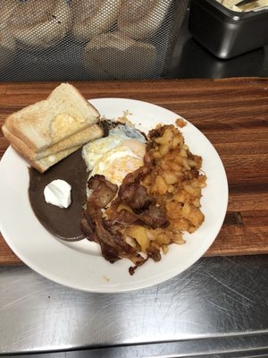 Eggs beans and fresh home fries with bacon and toast