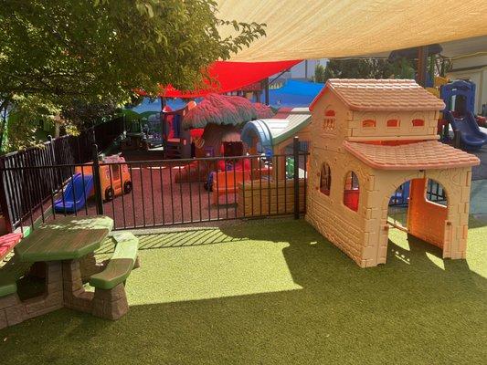 The Little Prodigy Preschool and Daycare Center with a picnic table and play house.