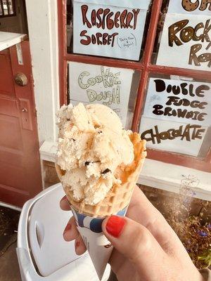 Single scoop of chocolate chip cookie dough in a waffle cone