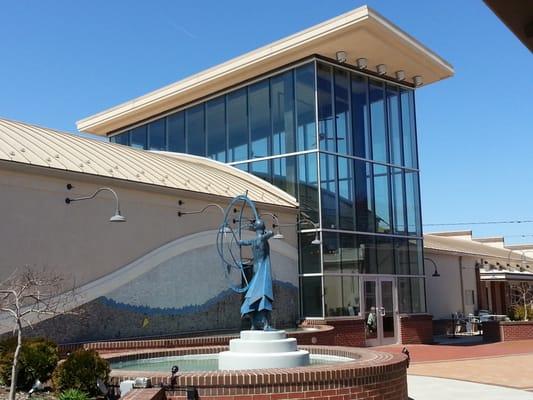 Glass tower gallery entrance and "Aiming for the Mark" statue pond.