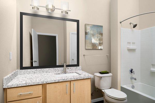 Upgraded bathrooms with framed mirrors and contemporary fixtures