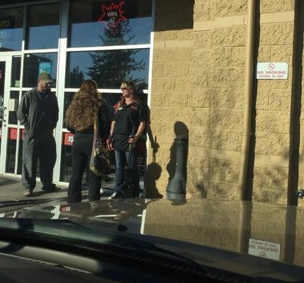 Employee smoking next to entrance and no smoking sign. Thank you for sharing with the rest of us.