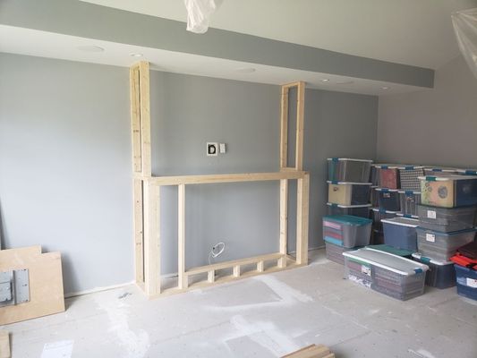 This is the start to a custom gas fire place build, with 3 custom built library cabinets, with adjustable shelving on each side.