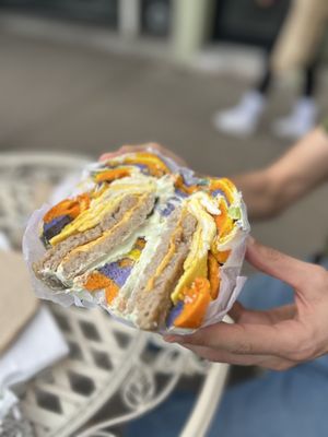 Rainbow bagel with sausage egg and cheese