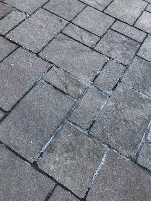 They were hired to fill sand into areas between the pavers that were missing sand. The pavers are now stained, peeling, still no sand.