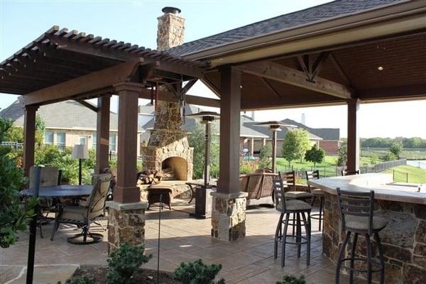 Outdoor Living area with stone fireplace, outdoor kitchen and living areas.