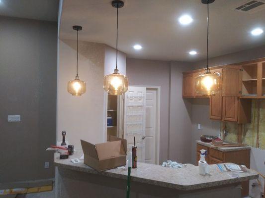 Added recess lights and pendulum lights over bar in kitchen