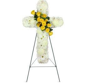 Always elegant all white cross designed with a spray of yellow roses for remembrance....