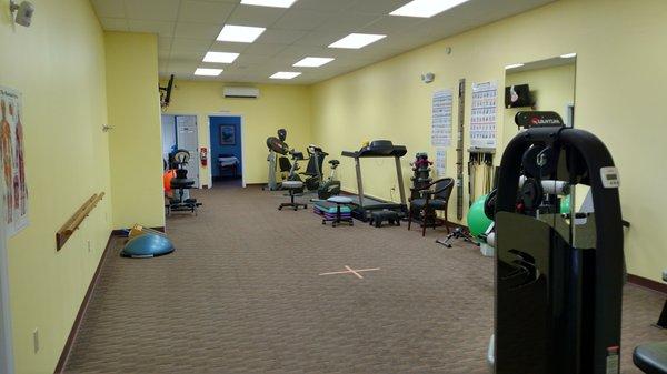 Large gym area with four private treatment rooms.