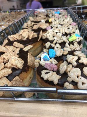 Close up of the Lucky Charms donut and Cinnamon Toast Crunch donut.