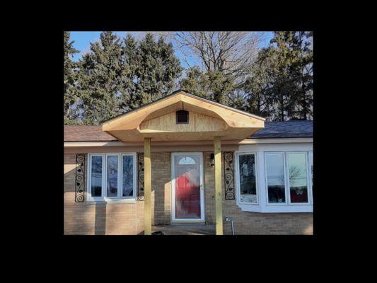 Custom front entry dormer built into existing roof line.