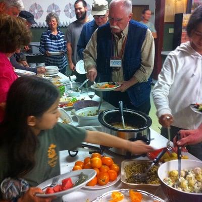 Gathering people, nourishment, and wisdom directly from the land to the Grange's lively table for monthly potluck and event.