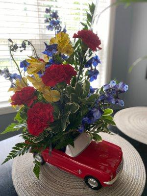 alstroemeria, carnations, chrysanthemums, delphinium, sinuata statice, leatherleaf & sword fern in a '65 Ford Mustang