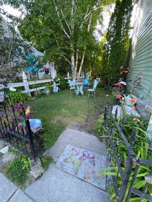 The beautiful side garden; artist meet and greets are held here and all kinds of yard art that's for sale through the shop.