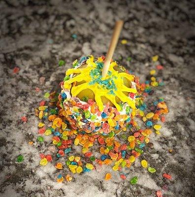 Fruity pebbles apple topped with yellow chocolate and blueberry pop rocks