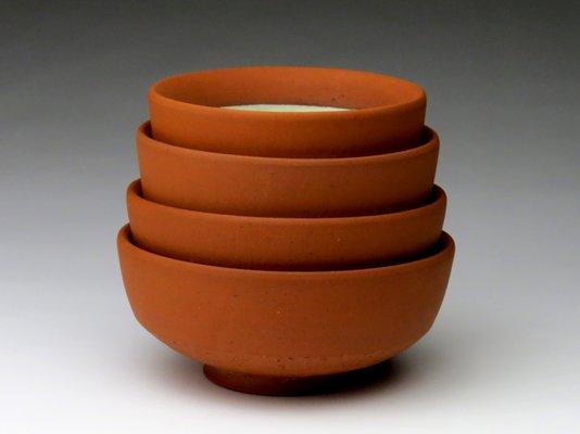 Nesting bowls made of brick clay.