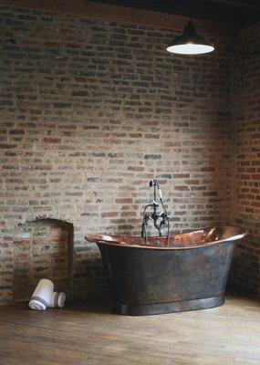 Copper Bateau bathtub with a highly polished interior and French patina exterior.