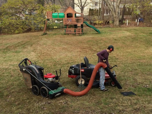 Toro zero turn mower and Billy Goat leaf vacuum in action.