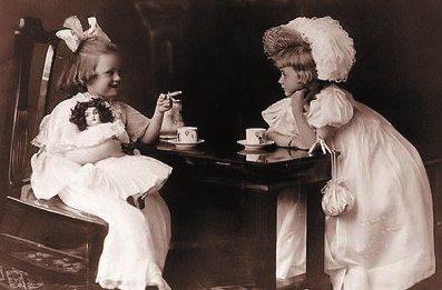 two children enjoying tea