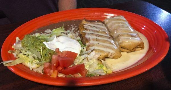 Dos Chimichangas ($10) were nicely fried, covered in runny cheese and stuffed with flavorful shredded chicken.