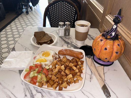 Over easy eggs, sausage and home fries. Side of wheat toast. Black tea with lemon and honey