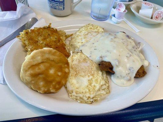 Country fried steak, eggs over medium, hash, and a biscuit