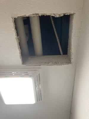 Jagged hole cut in the bathroom ceiling