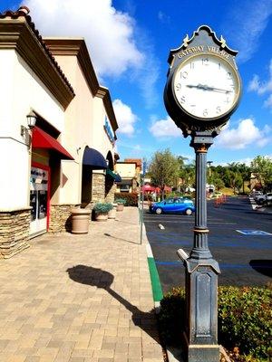 The stores at Gateway village with the cool clock sign