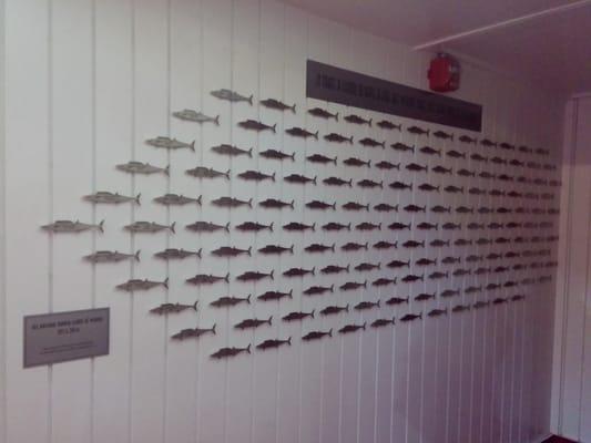 Each fish is engraved with a swimmer's name