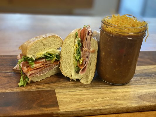 Our delicious deli grinder sandwich with a jar of our housemade chili!