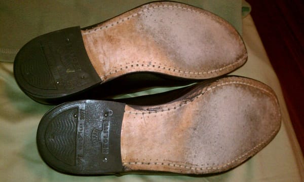 Resoled shoes.  Wear on soles is from wearing them three times.