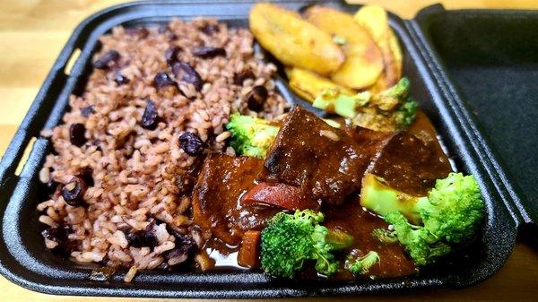 Brown Stew Tofu with Rice and Peas, Served with vegetable Salad and plantains