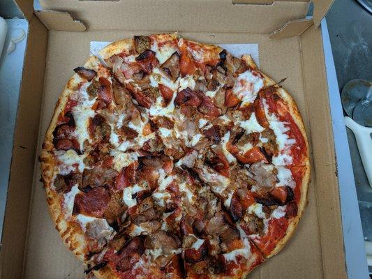 Carnivore pizza with lots of pepperoni, meatball and sausage.