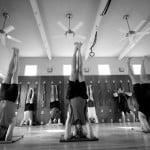 Men doing various forms of headstand