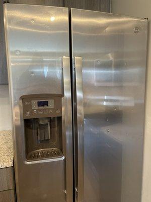 fridge with dozens of dents from bb gun