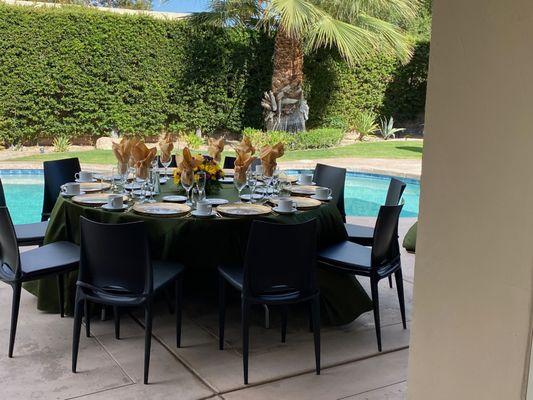 Beautiful tables set up in our back area with gold napkins and gold-plate utensils for our Golden Wedding Anniversary