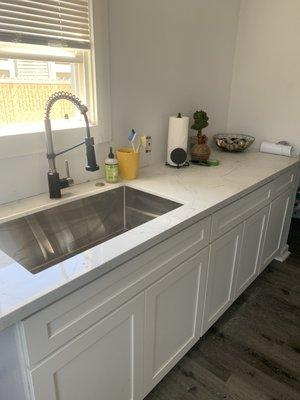 New base cabinets, counter and sink + faucet, plus air drop for garbage disposal