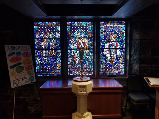 Narthex stained windows and baptismal font.