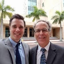 Lee County Attorney Hagen with son outside an agricultural exemption hearing on property tax and real estate law.