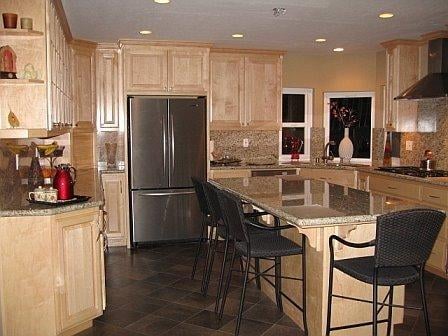 New maple cabinets, new granite counter tops and backsplash, new wiring and can lights, and new tile floor